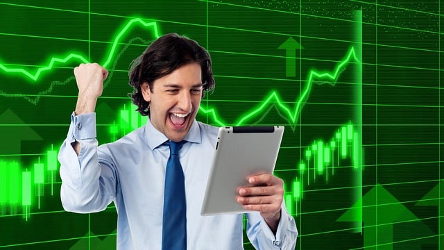 Man celebrating success with tablet.